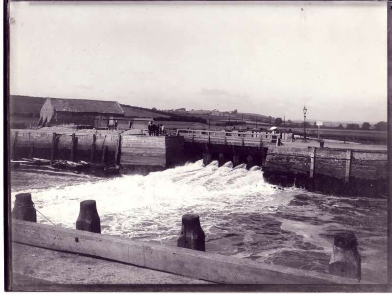 Hand operated sluice gates to purge harbour channel of silt